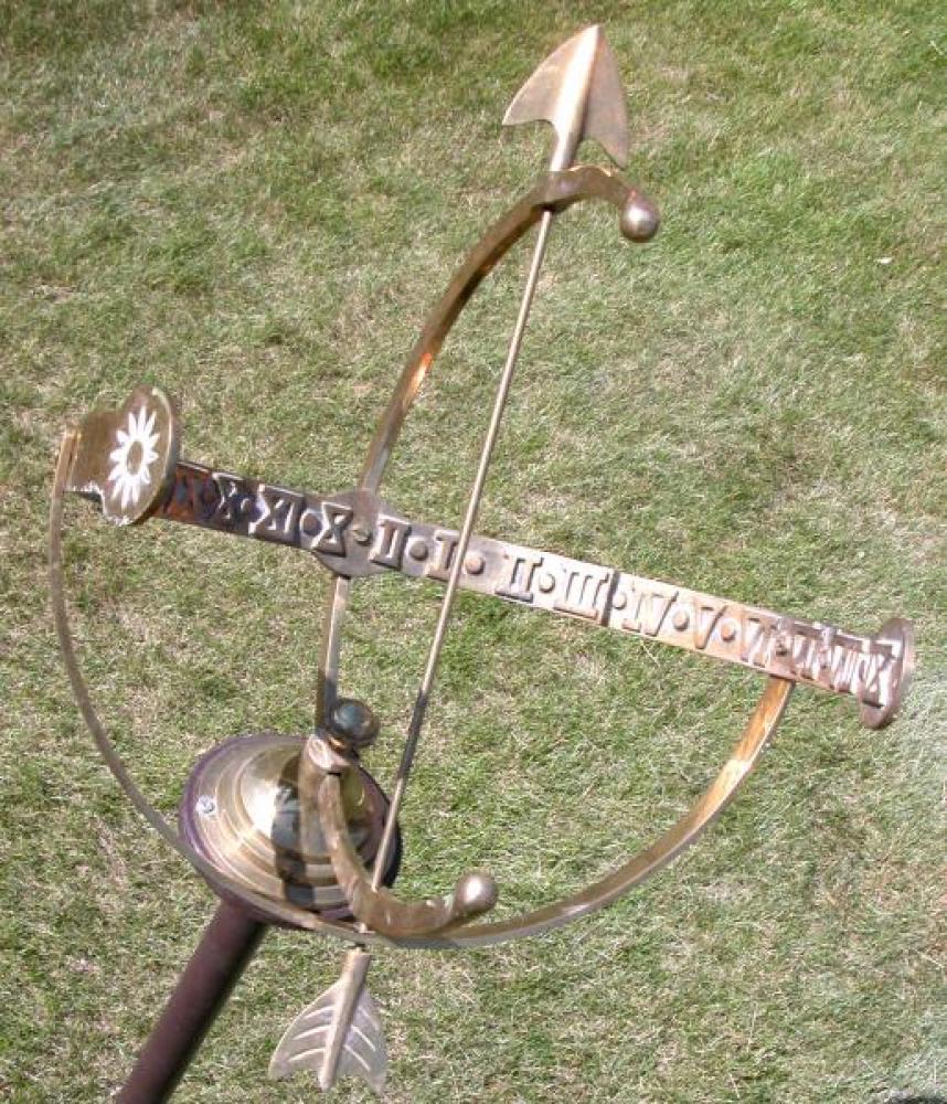 Closeup of armillary sundial showing time almost 3:30 p.m.