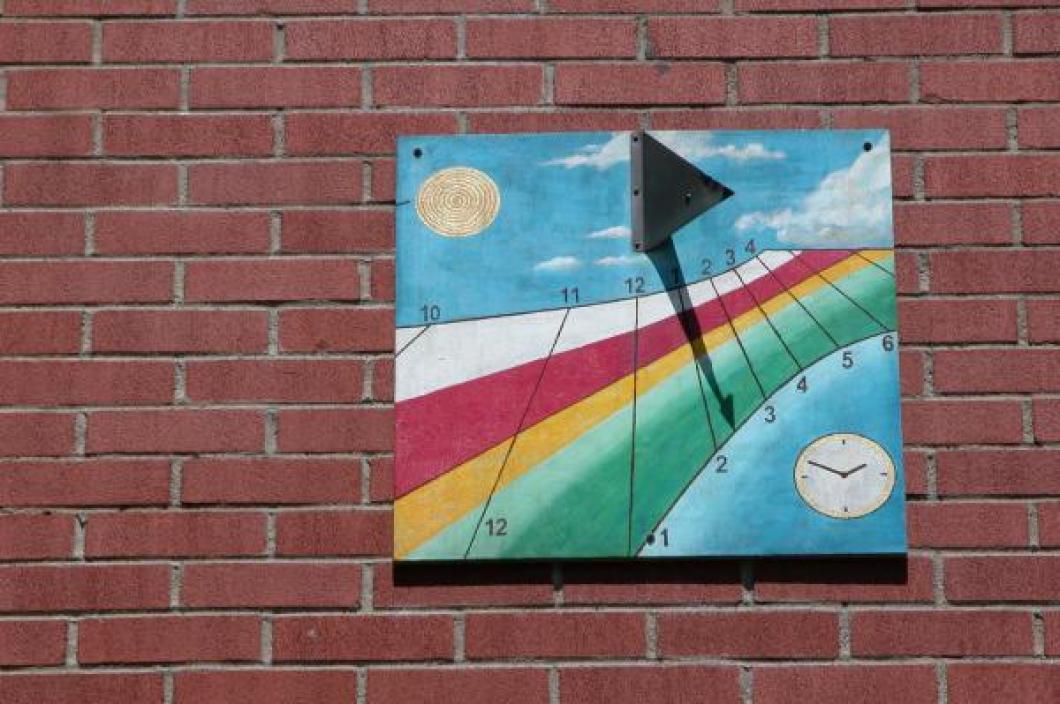 Close-up of our front wall sundial taken June 22, 2009 (note shadow tip on lower black line the day after "longest" day)