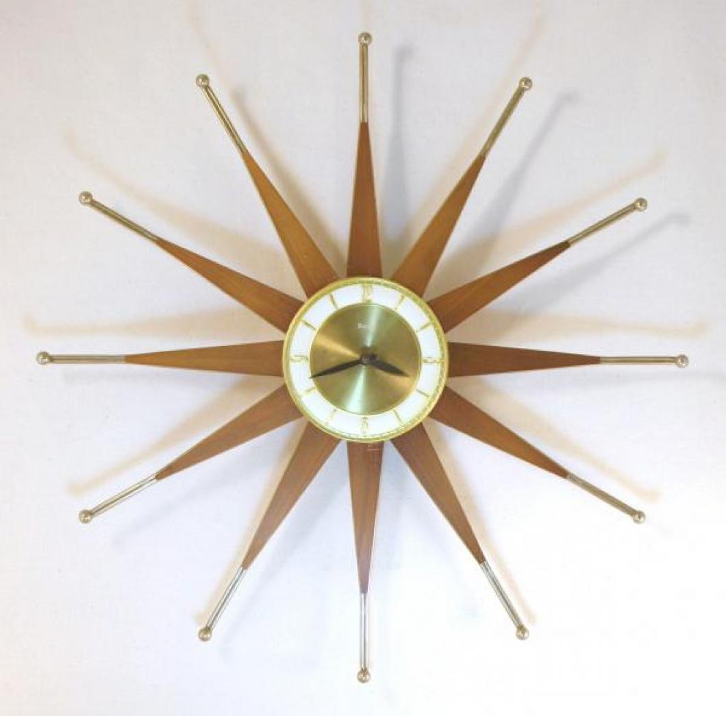 Snider starburst wall clock with brass-plated, ball-tipped, metal-rod frames holding tapered wood rays (early/mid 1960s, electric)