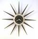 Snider large starburst wall clock, simple design with black dial and 12 long wood cones, black finish (early/mid 1960s, electric, part of the Spanish series)