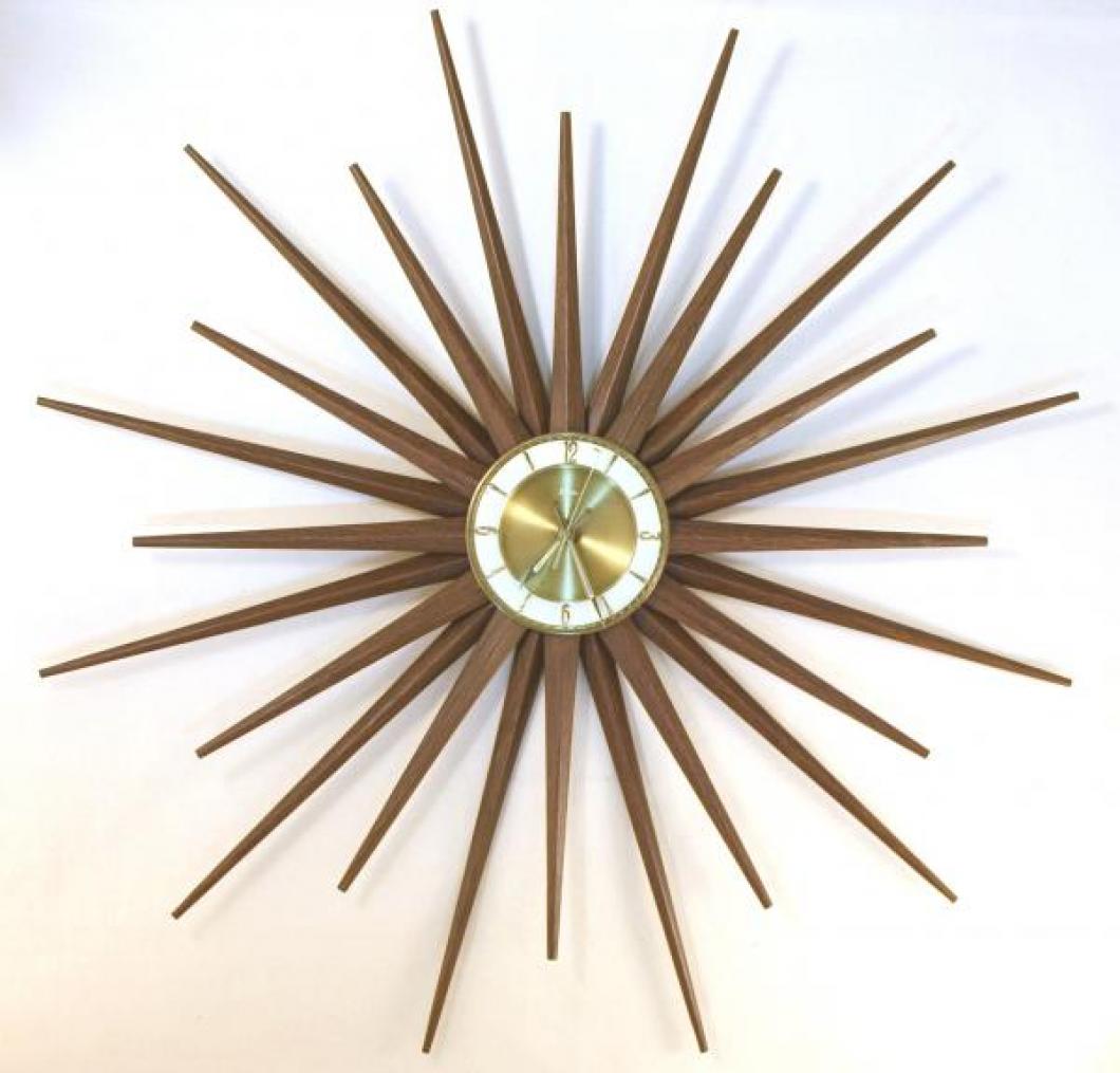 Snider large starburst wall clock with walnut-grained finish on sheet metal rays (early/mid 1960s, electromechanical battery movement)
