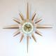 Snider starburst wall clock with brass-plated metal rod frame and short and long walnut wood rays (early/mid 1960s. electric) 