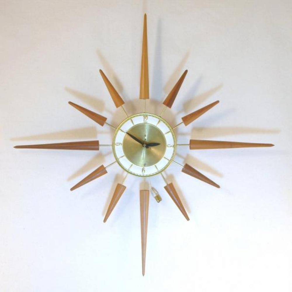 Snider starburst wall clock with brass-plated metal rod frame and short and long walnut wood rays (early/mid 1960s. electric) 