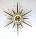 Snider starburst wall clock with brass-plated rods and short and long walnut wood rays (early/mid 1960s, electric)