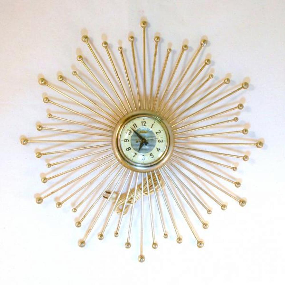 Snider sunburst "fireworks" wall clock with many brass-plated metal rod rays, glass cover over dial (late 1950s, electric)