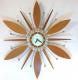 Snider starburst wall clock with brass-plated metal rods, alternating walnut cones and "petals" (1960s, electric)