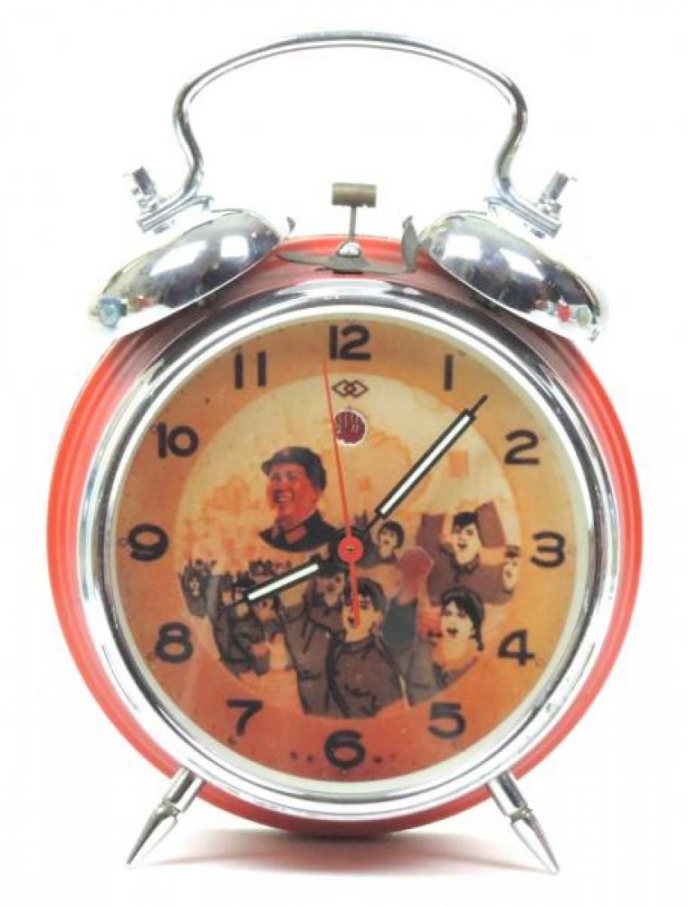 Double Rhomb animated alarm clock with red-painted metal case and double bells (windup, late 1960s, China)  [note Chairman Mao on dial, student's animated arm waves his Little Red Book, the Cultural Revolution]