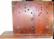 The OUTSIDE of the wood BACK plate; note the square lignum vitae bushings