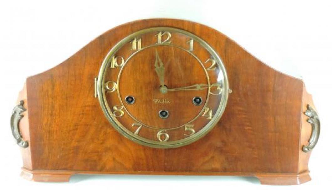 The post-war STYLE 107 mantel clock with walnut case, metal applique name Walter on the dial.