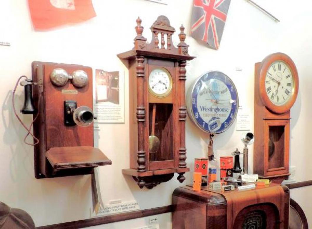 Canadian-made 1914 wall telephone, 1930s Northern Electric floor model tubes radio, Pequegnat BEAVER model wall clock in the Pequegnat Room.