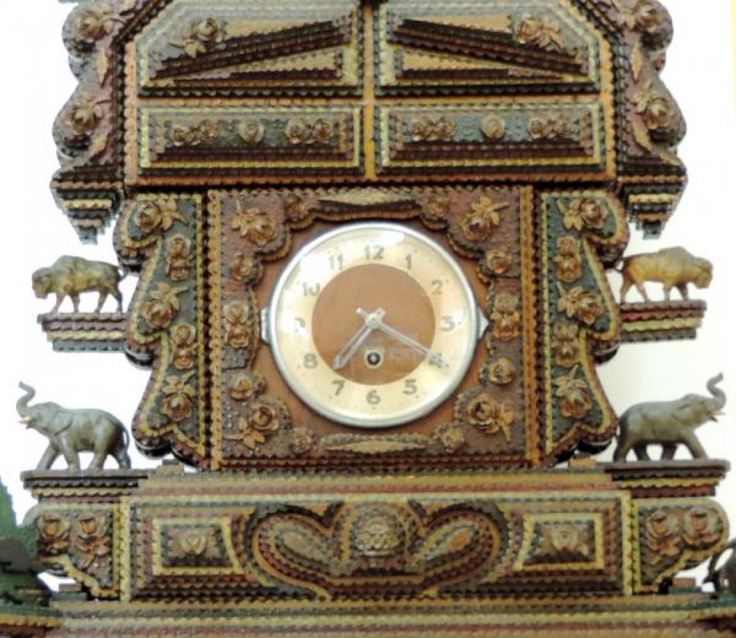 The central area of Harry Sykes 'tramp art' clock showing the clock dial
